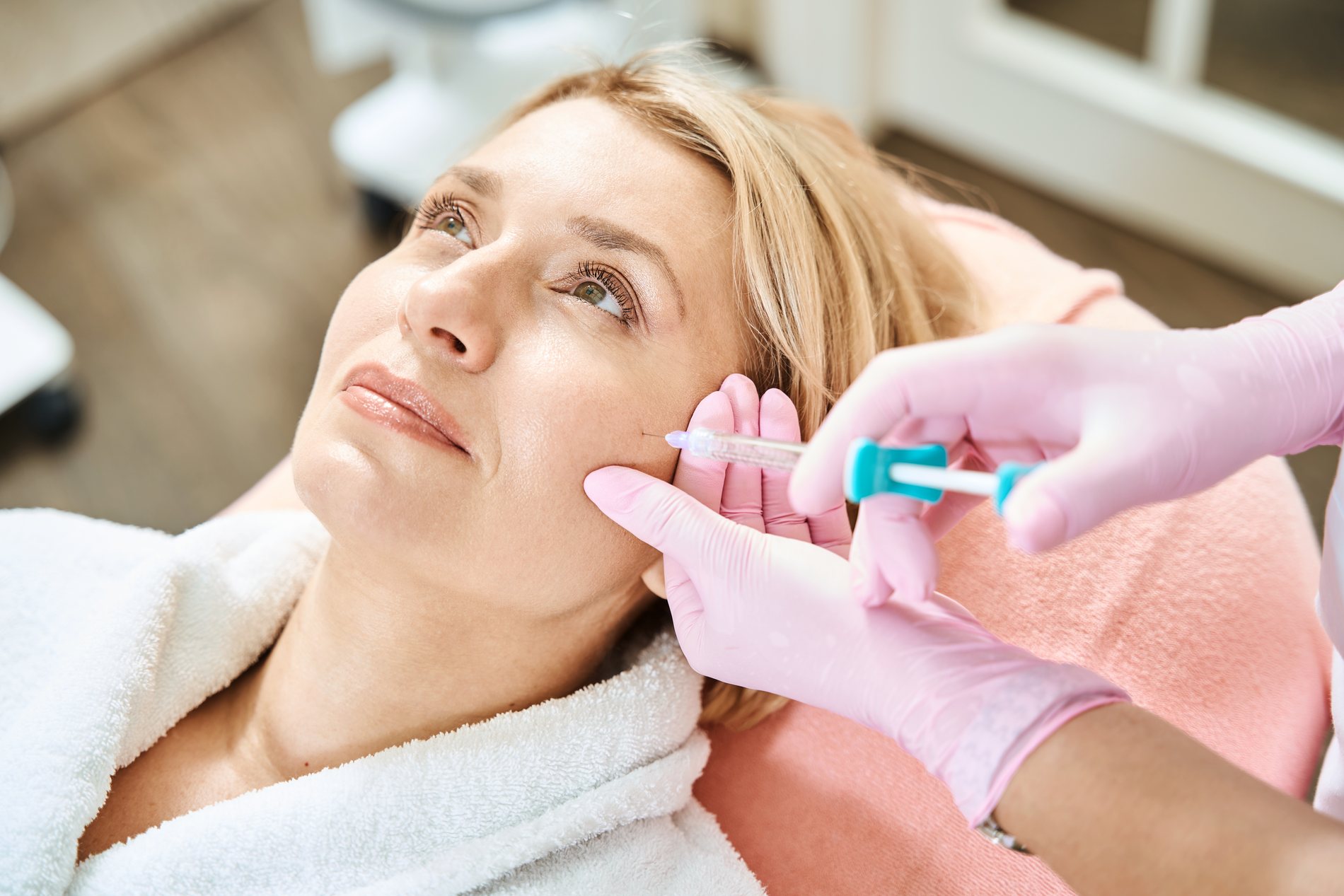 A physician assessing a patient's skin